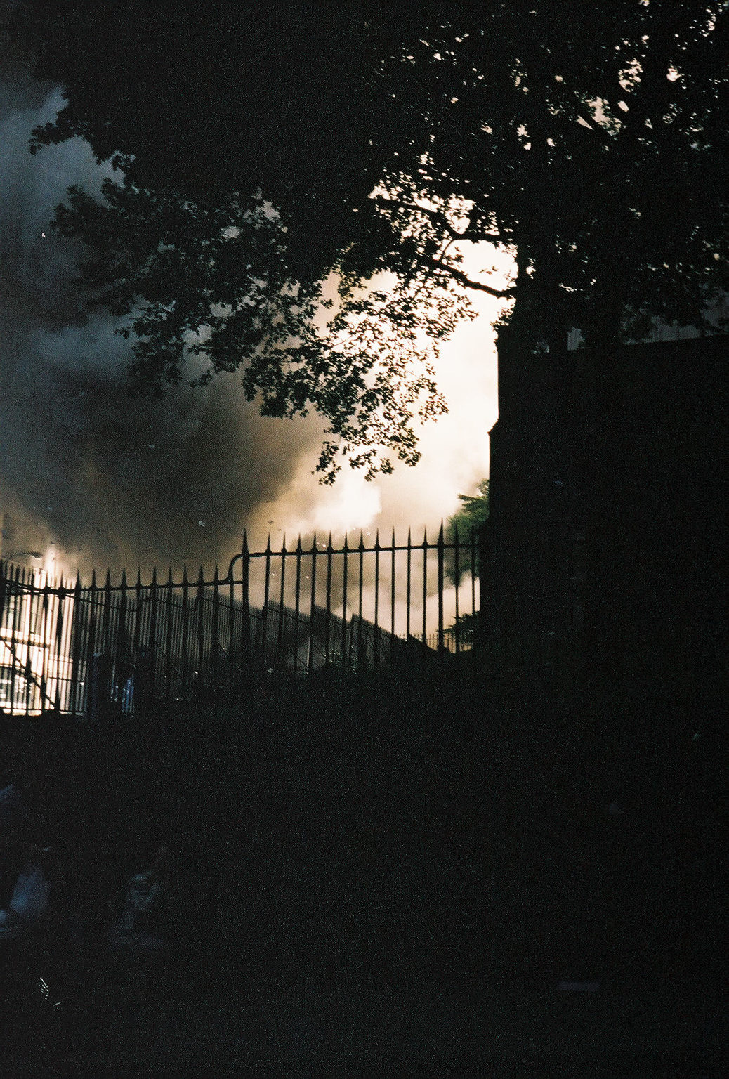 Trinity Church across the street, people cowering by the wall as they run from the collapsing tower.