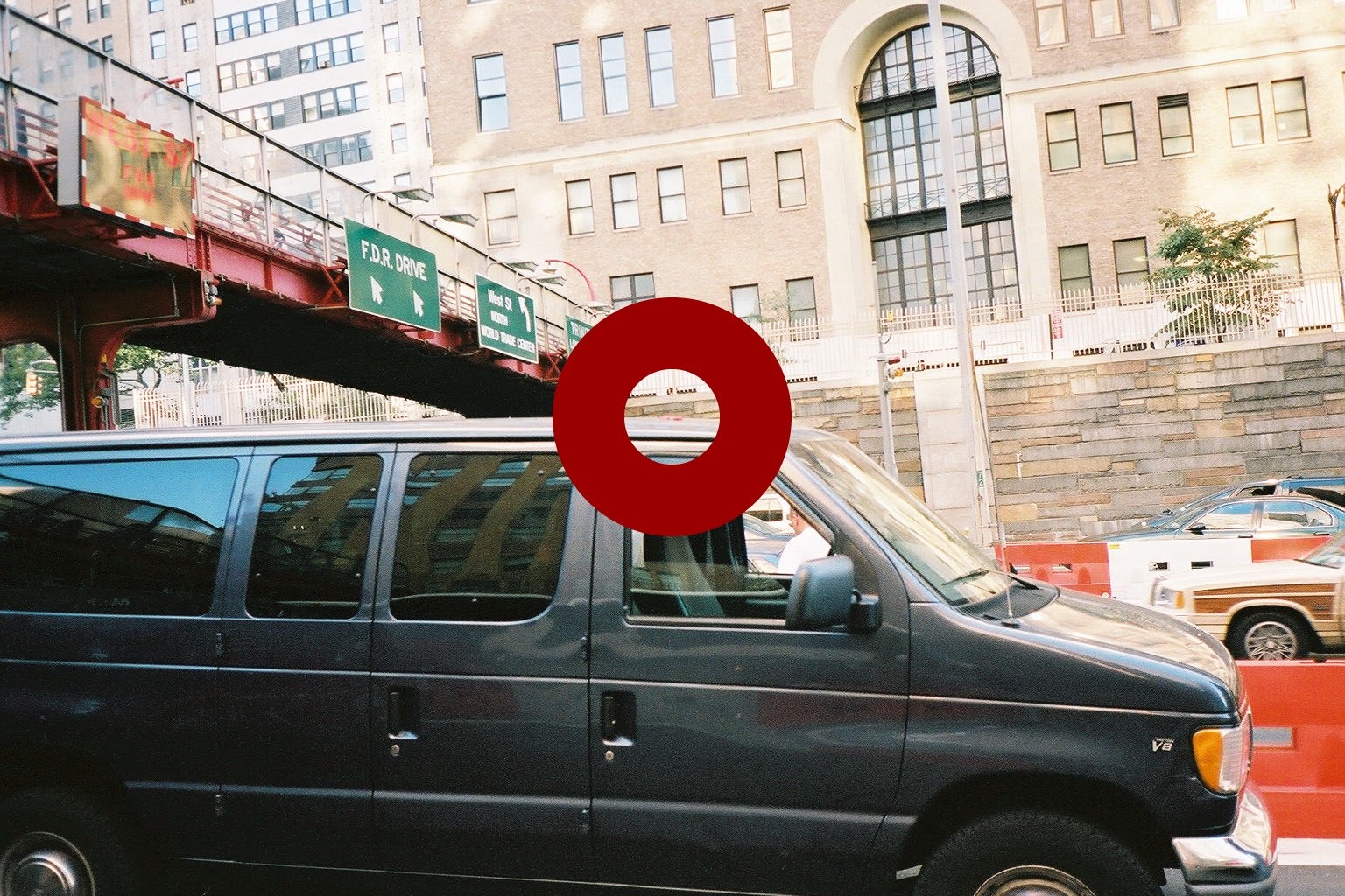 A second frame of the debris on the red van's roof, also from the first impact.